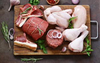 A cutting board full of raw meat