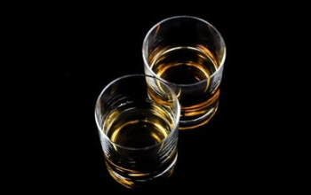 Shots of whiskey on a black background